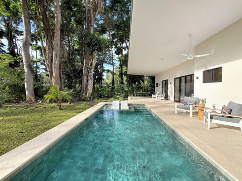 outside sitting area with swimming pool and gorgeous garden