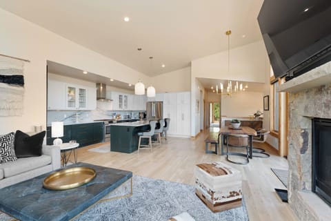 Step into your open-concept haven where modern elegance meets mountain comfort. Gather around the chef's kitchen, unwind by the stone fireplace, and let natural light fill your space.