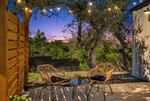 Your evening plans, sorted. The cozy patio with string lights and a stunning sunset backdrop is waiting for you.