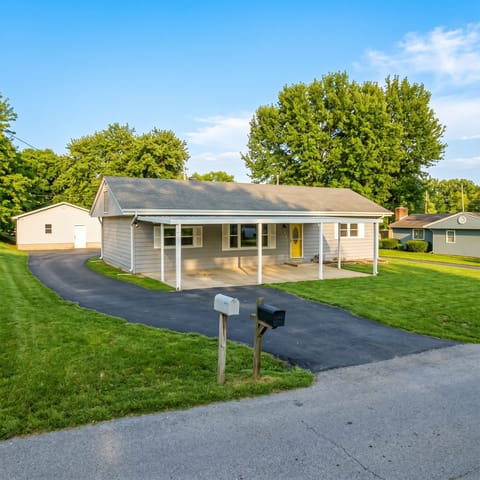 Charming ranch with covered porch, long drive, big yard & garage