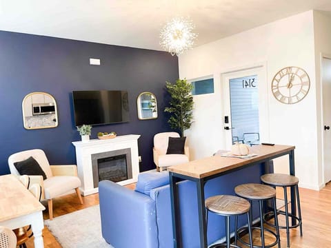 Open concept living area with dining bar and comfy furnishings for perfect TV viewing + sleeper sofa (sleeps 2)