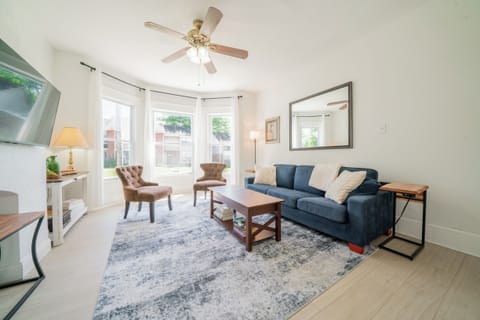 Movie night! Kick back on the deep velvet sofa by the bright bay windows.
