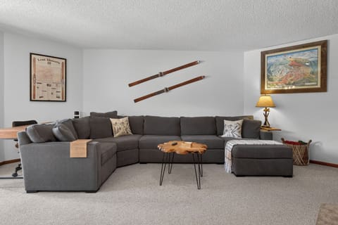 Gather your group on this spacious wraparound sectional where mountain charm meets modern comfort—perfect for movie nights or morning coffee together.