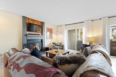 Sink into plush seating by your cozy fireplace, where warm textures and soft lighting create the perfect retreat after a day of adventure.