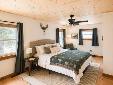 Primary bedroom with recessed lighting and tongue and groove ceiling.
