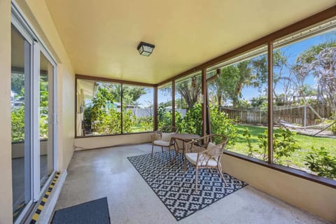 Relax on the screened patio overlooking the lush backyard garden.