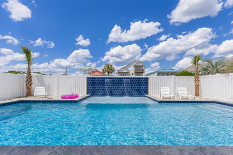 Private resort-style pool with waterfall features, ideal for relaxing after a day at the beach in Oak Island, North Carolina.