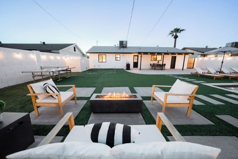 Inviting backyard lounge area centered around a modern rectangular fire pit, ideal for evening entertaining.