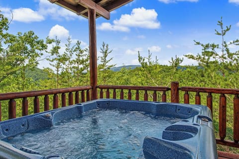 Soak in your private hot tub while soaking up sweeping mountain vistas under a sunny sky—pure relaxation awaits on your covered deck.