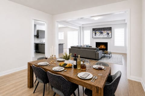 Bright open dining and living space with fireplace and seating for six