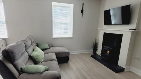 Bright, modern living area with cosy stove a perfect space to relax 