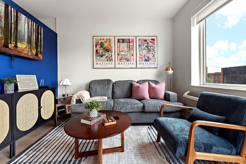 Relax in a thoughtfully designed living space with modern furnishings, warm accents, and a comfortable setup.