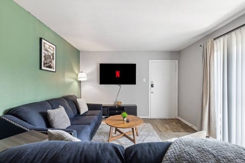 Spacious and inviting living area with comfortable seating and a smart TV, perfect for relaxing after exploring Arlington or attending events at AT&T Stadium.
