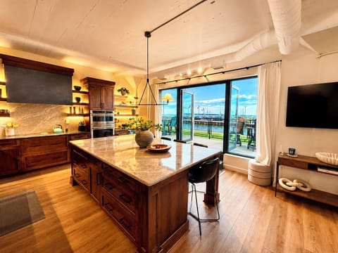 Warm ambient lighting, rich wood finishes, and a chef-inspired kitchen create the perfect setting for late-night wine, conversation, and unforgettable evenings by the lake.