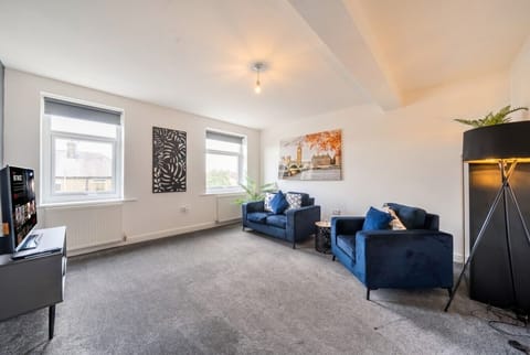 Unwind in the airy lounge with velvet armchairs and a smart TV.