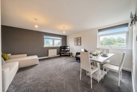 Bright open lounge and dining space with countryside views from every window