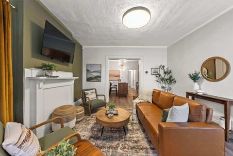 Bright living room w/ mounted TV & cozy seating for movie nights in.