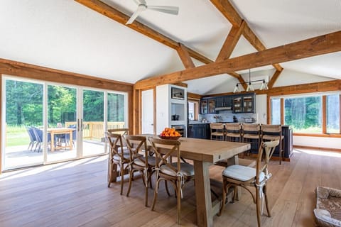 Spacious open-concept kitchen and dining area with sliding glass doors to the back deck