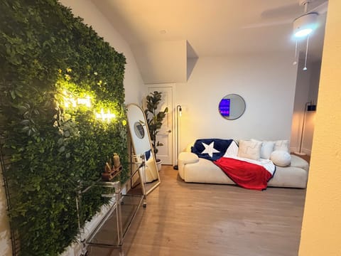 Chic lounge with greenery wall, cozy sofa, and stylish modern decor