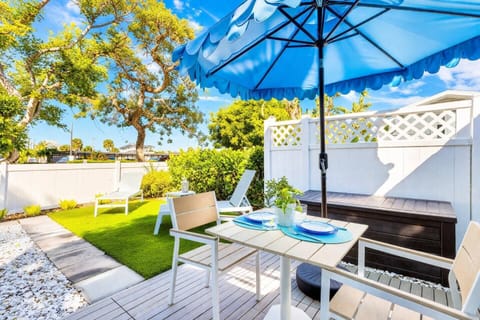 Private tropical patio with shaded dining, lush greenery, and lounge chairs—perfect for morning coffee or sunset drinks in your own Florida oasis.