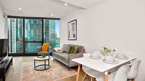 Bright and inviting living and dining area with city views.