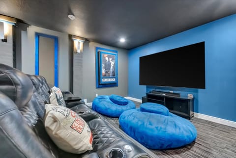 Reclining theater seats face the oversized screen