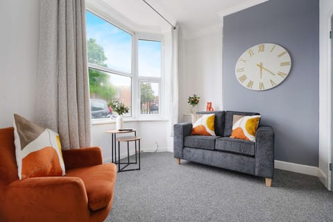 The welcoming living room offers comfortable seating, a wall-mounted Smart TV, and plenty of natural light, creating the perfect setting to relax after a busy day in Darlington or the surrounding area.
