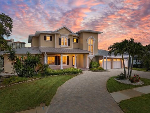 This spacious two-story waterfront home is designed for laid-back coastal living, with comfortable furnishings, multiple gathering spaces, and direct views of the sparkling bay.