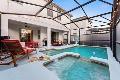 ☀️ Relax in your private oasis! This screened-in pool & spa area features comfy loungers, a BBQ grill, and outdoor dining. Enjoy poolside fun  or unwind in the hot tub under twinkling lights. Perfect for families & groups!  #VacationVibes
