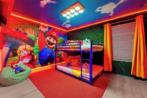  Enter a real-life video game in this Mario-themed bedroom! With vibrant murals, glowing LED lights, and cozy bunk beds, this space is perfect for little gamers. Plush character pillows & fun decor bring the magic to life! ⭐️