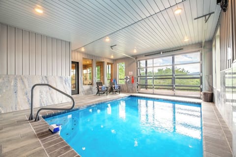 Your own private indoor pool awaits, with sunlight streaming through the windows and cozy lounge chairs ready for relaxation. Slip into the sparkling water anytime you like.