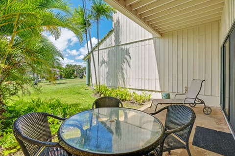 This covered patio is your sunny retreat, with comfortable seating and lush tropical gardens steps away. Enjoy morning coffee here or simply unwind with a view of swaying palms.