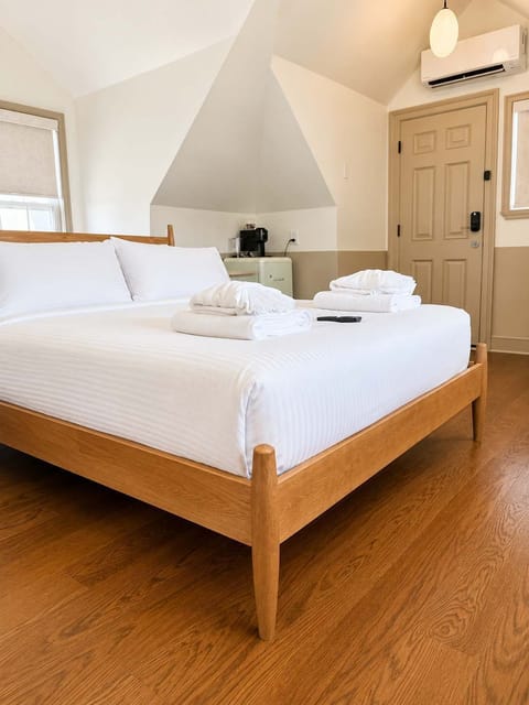 Unwind in a thoughtfully designed bedroom featuring premium linens, boutique-inspired décor, and a peaceful atmosphere for a restful night's sleep.