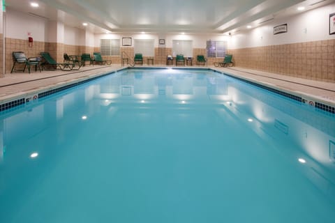 Indoor swimming pool with surrounding pool deck.