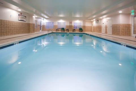 Indoor swimming pool with clear blue water.
