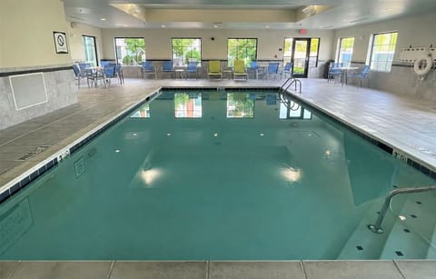 Dive into relaxation in the indoor pool, surrounded by natural light and comfortable seating.