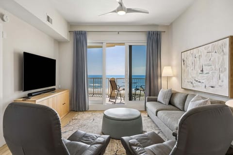 Oceanfront Living Area with Private Balcony Access and Large Flat Screen Smart TV