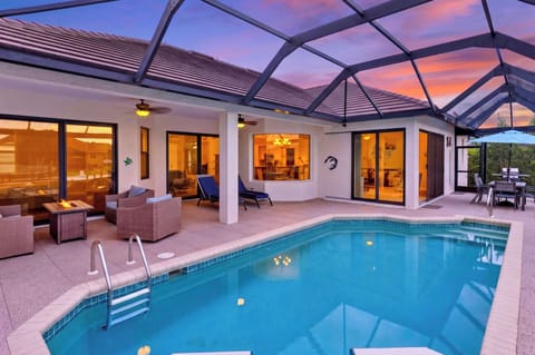 Alternative evening perspective of the illuminated pool area.