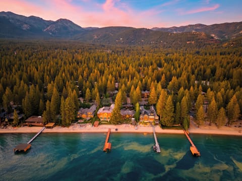 The property offers scenic access to the lakefront, featuring long wooden piers stretching into the water.