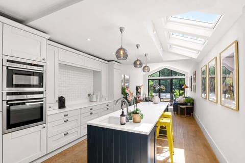 Gourmet Kitchen: Sunlit skylights and a chic navy island make cooking a true delight!