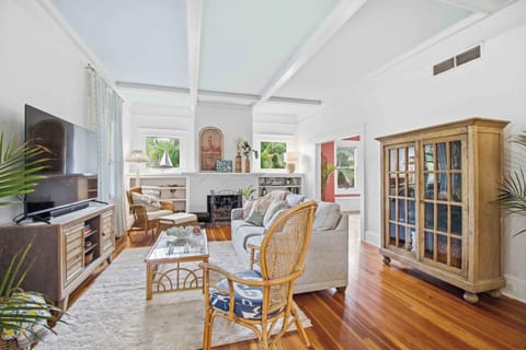 Large windows and tall ceilings fill the living room with natural light