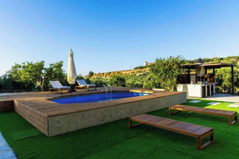 Spacious outdoor deck with pool and landscaped garden area.