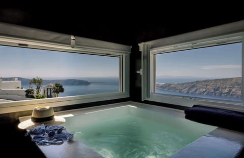 Private indoor jacuzzi with breathtaking sea views for a relaxing escape.