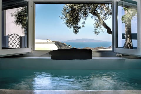 Relax in the private jacuzzi with sweeping Aegean views just steps away.