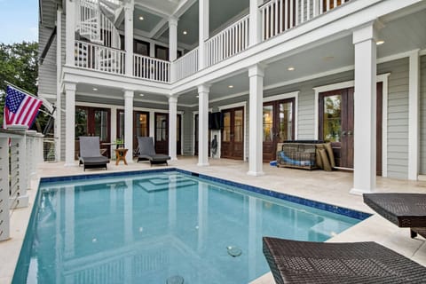 A peaceful poolside retreat awaits behind this classic Southern home, where you'll find multiple levels of covered porch space perfect for morning coffee or evening relaxation.