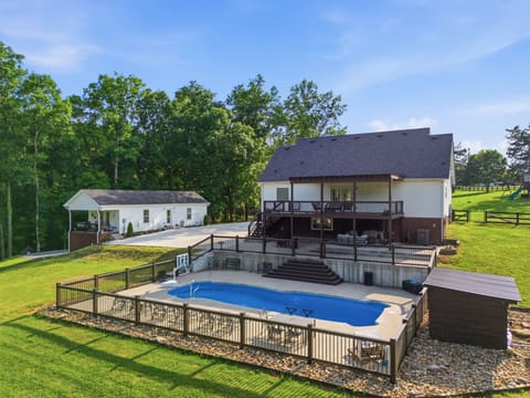 Take in the scenic surroundings from this stunning property, complete with a large private pool, outdoor seating, and plenty of space for making unforgettable memories.