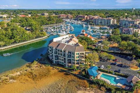 Yachts bob in the sparkling marina just steps from this coastal sanctuary, where golden marshlands meet the turquoise pool. Terracotta rooftops glow under the afternoon sun, offering a picturesque backdrop for your seaside getaway.