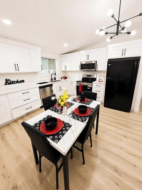 Modern kitchen with stainless steel appliances and dining for 4.