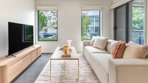 Bright open plan living with comfortable seating and smart TV
