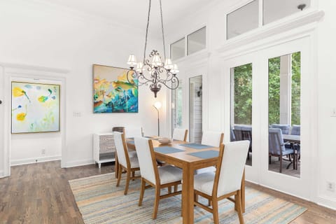 Bright and airy dining room looks out to the screened porch